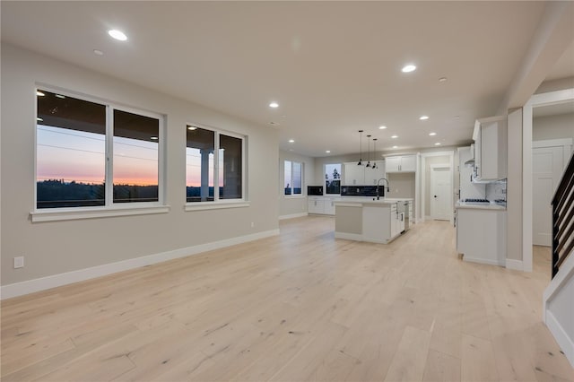 20239 125th Ave NE Unit Sm2-11, Bothell, WA 98011 - unfurnished living room featuring recessed lighting, baseboards, a sink, and light wood finished floors