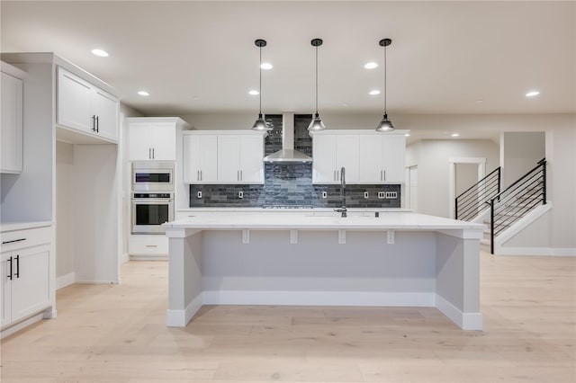 20239 125th Ave NE Unit Sm2-11, Bothell, WA 98011 - kitchen featuring wall chimney range hood, appliances with stainless steel finishes, backsplash, and a sink