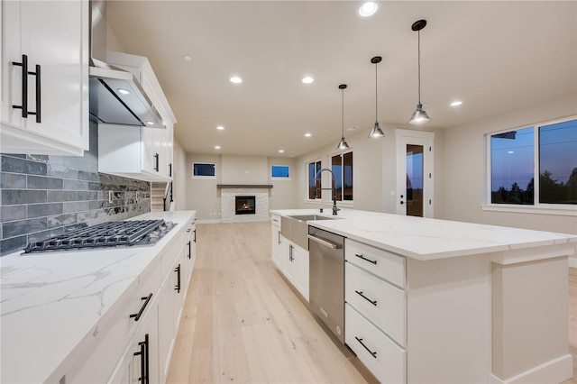20239 125th Ave NE Unit Sm2-11, Bothell, WA 98011 - kitchen featuring a sink, light wood-style floors, stainless steel appliances, backsplash, and a center island with sink
