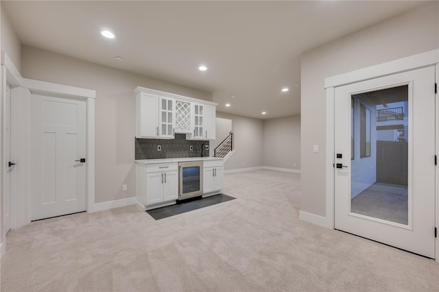 20239 125th Ave NE Unit Sm2-11, Bothell, WA 98011 - kitchen featuring carpet floors, white cabinets, glass insert cabinets, and wine cooler
