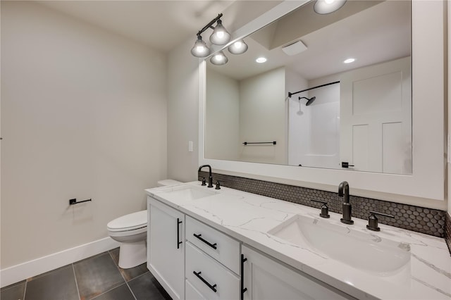20239 125th Ave NE Unit Sm2-11, Bothell, WA 98011 - bathroom featuring toilet, baseboards, a sink, and tasteful backsplash