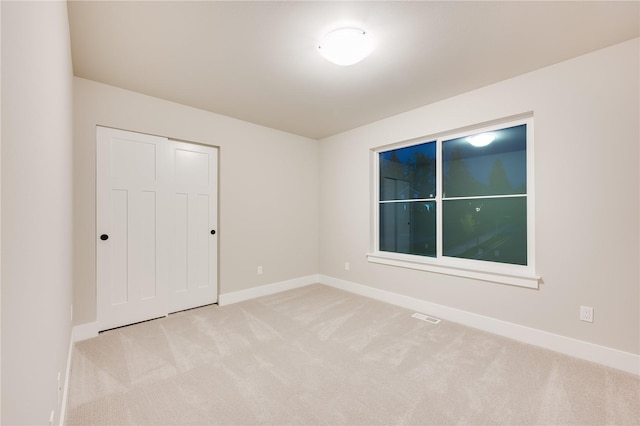 20239 125th Ave NE Unit Sm2-11, Bothell, WA 98011 - unfurnished bedroom featuring baseboards, carpet, a closet, and visible vents