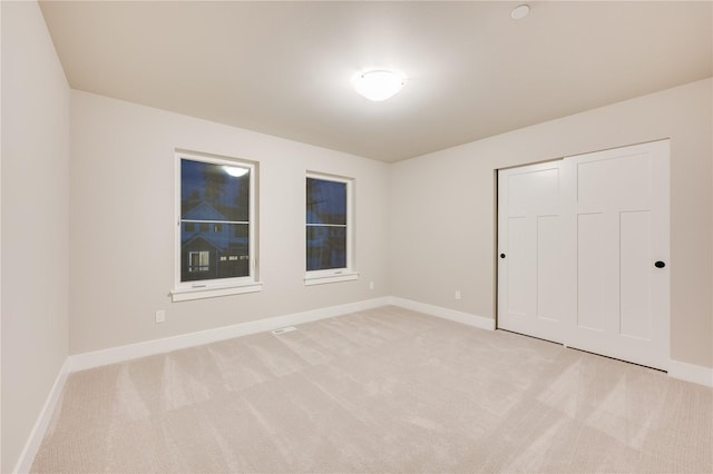 20239 125th Ave NE Unit Sm2-11, Bothell, WA 98011 - unfurnished bedroom featuring baseboards, a closet, and light carpet