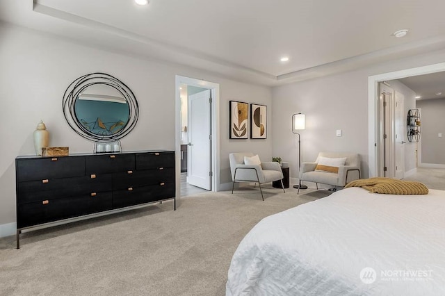 carpeted bedroom featuring a tray ceiling