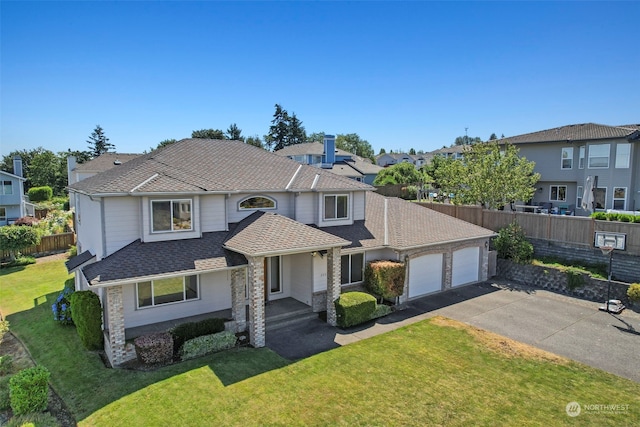 view of front of house featuring a front lawn and a garage