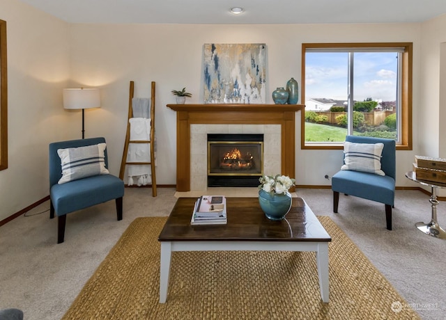 living area featuring light colored carpet and a tiled fireplace