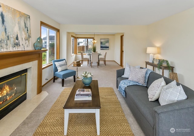 carpeted living room with a tile fireplace