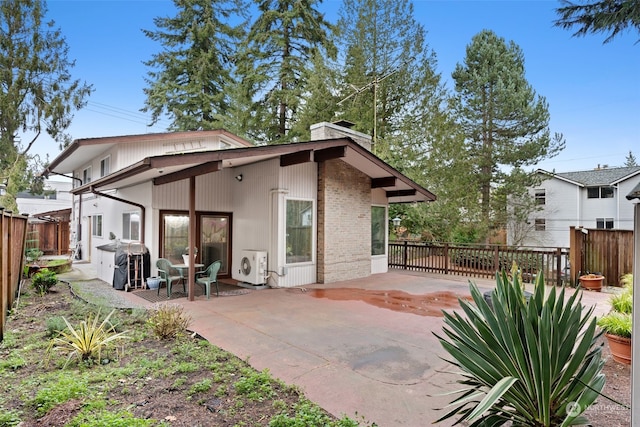 rear view of property with ac unit and a patio area