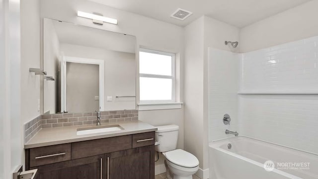 full bathroom with decorative backsplash, vanity, toilet, and shower / bathtub combination