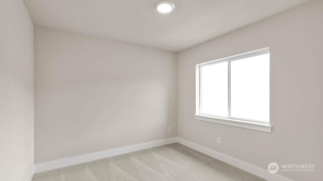 spare room featuring light colored carpet