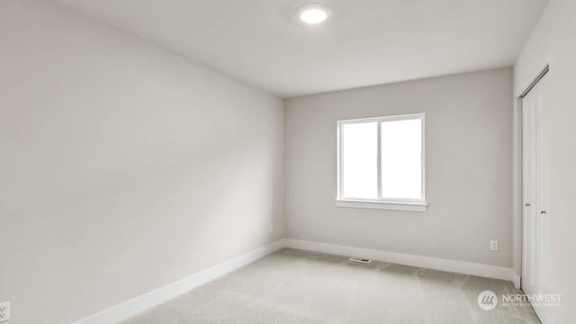 unfurnished bedroom featuring carpet flooring and a closet