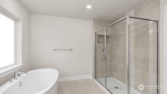 bathroom with separate shower and tub and tile patterned floors