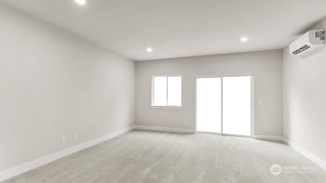 empty room featuring light carpet and a wall unit AC