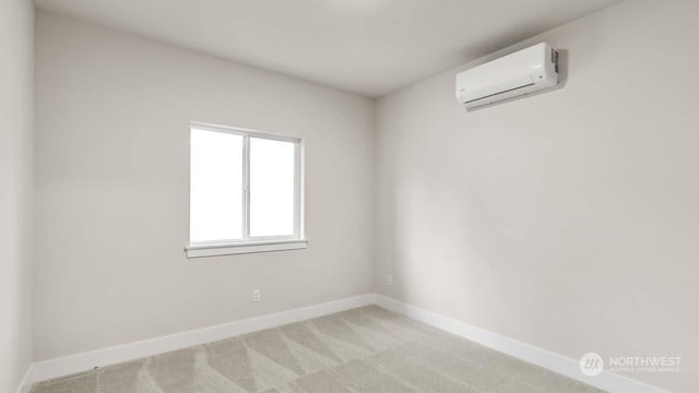 carpeted spare room featuring an AC wall unit