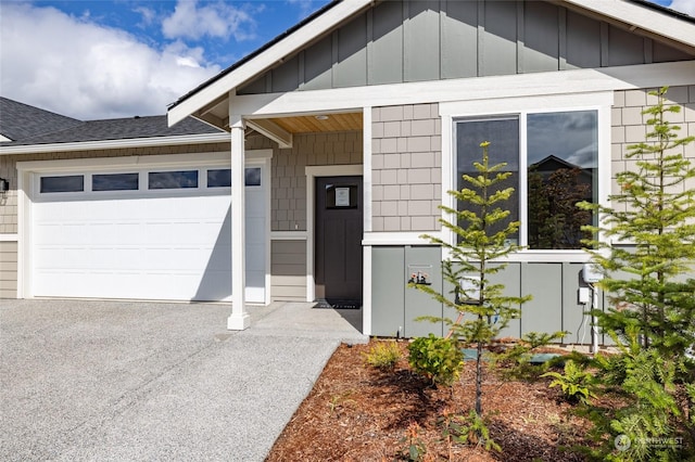 view of exterior entry with a garage