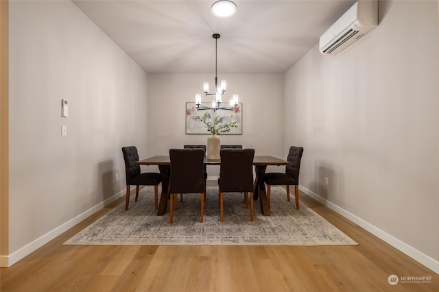 dining area featuring a wall mounted air conditioner, wood-type flooring, and a chandelier