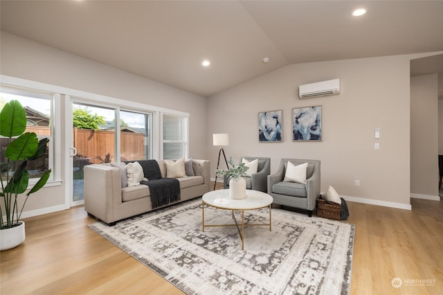 living room with an AC wall unit, vaulted ceiling, and light wood-type flooring