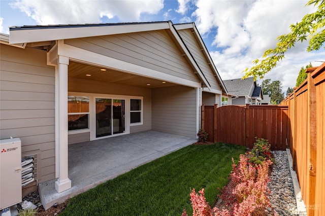 back of property featuring a yard and a patio