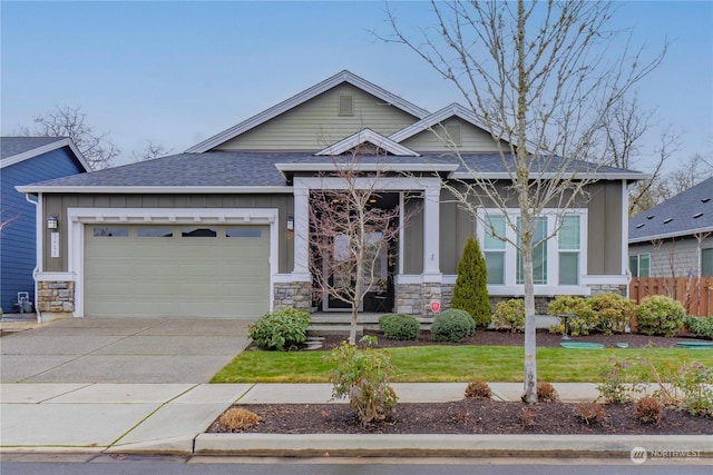 view of front of home with a front yard and a garage