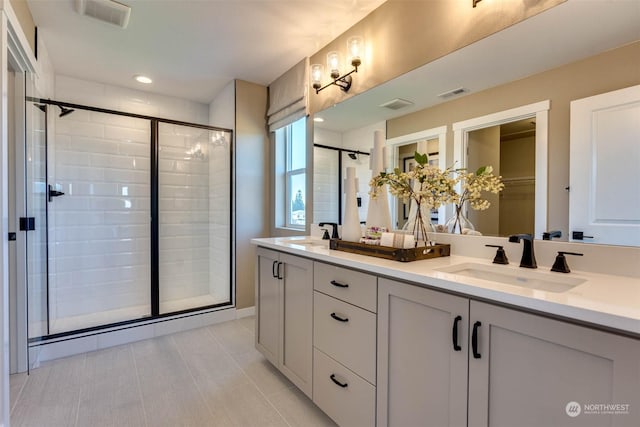 bathroom featuring vanity, tile patterned floors, and an enclosed shower