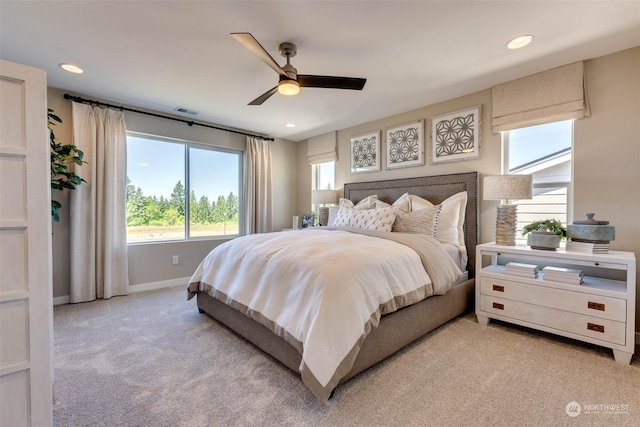 bedroom with ceiling fan and light carpet