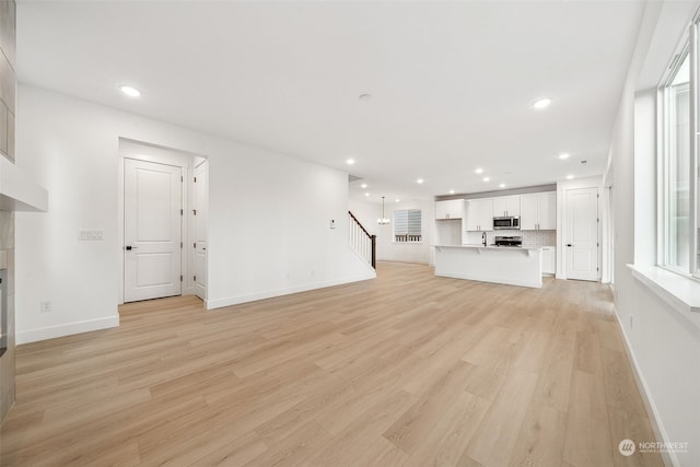 unfurnished living room featuring light wood-type flooring