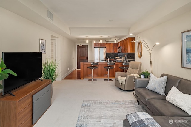 carpeted living room with sink