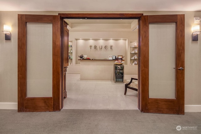 corridor featuring french doors and light tile patterned flooring