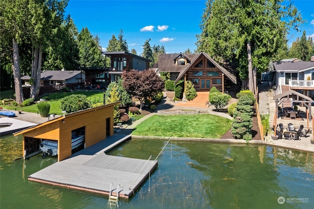 dock area with a yard and a water view