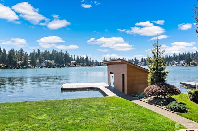 view of dock with a water view and a lawn