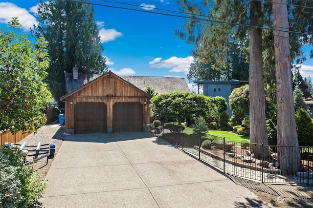 view of front of property with a garage and an outdoor structure