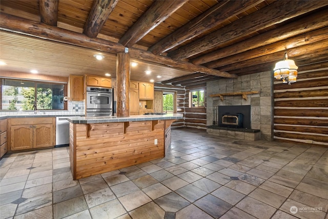 kitchen featuring decorative backsplash, a breakfast bar, stainless steel appliances, wooden ceiling, and beamed ceiling