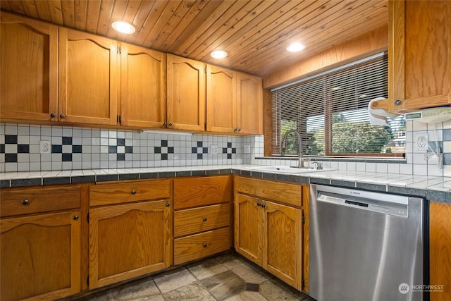 kitchen with tasteful backsplash, tile counters, sink, and stainless steel dishwasher