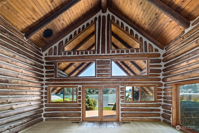 interior space featuring a water view, beamed ceiling, log walls, and wooden ceiling