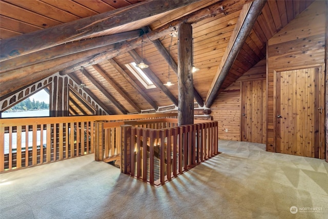 bonus room with carpet flooring, lofted ceiling with skylight, wooden ceiling, and wood walls