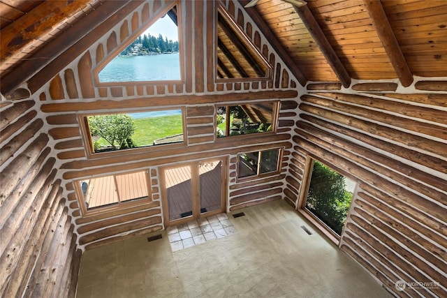 interior space featuring high vaulted ceiling, a water view, rustic walls, beamed ceiling, and wood ceiling