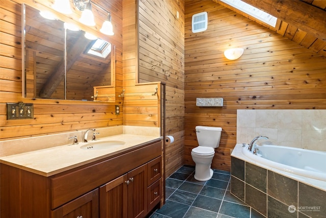 bathroom with vanity, tiled tub, toilet, and wooden walls