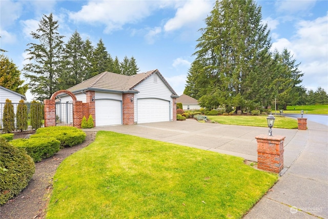 view of front of property with a garage and a front lawn