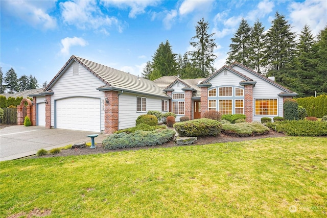 ranch-style house featuring a garage and a front lawn