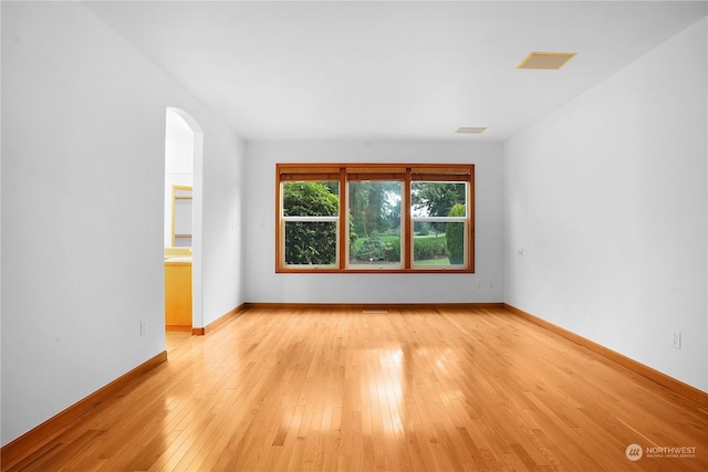 spare room featuring light hardwood / wood-style flooring