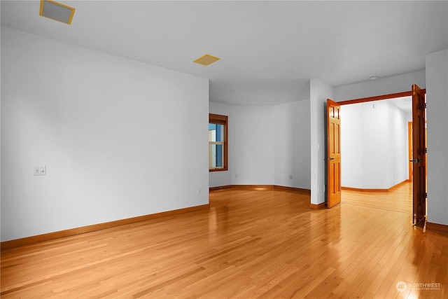 empty room with light hardwood / wood-style floors