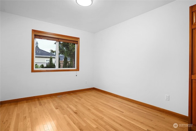 spare room featuring light wood-type flooring