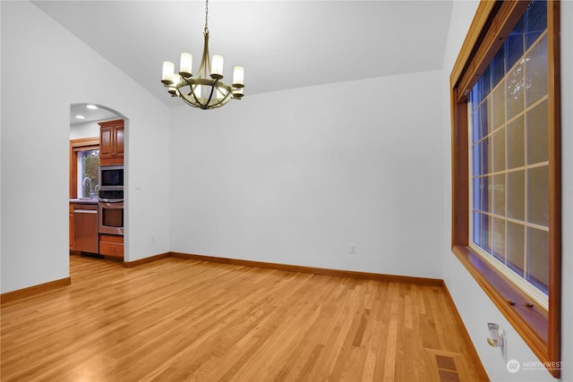 unfurnished room with light hardwood / wood-style floors, lofted ceiling, sink, and an inviting chandelier