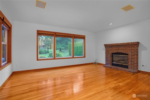 unfurnished living room with light hardwood / wood-style floors and a fireplace