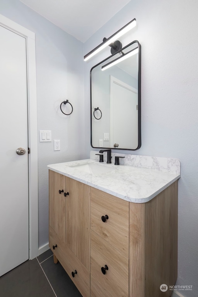 bathroom featuring tile patterned flooring and vanity