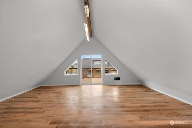 bonus room featuring vaulted ceiling with beams and light hardwood / wood-style floors