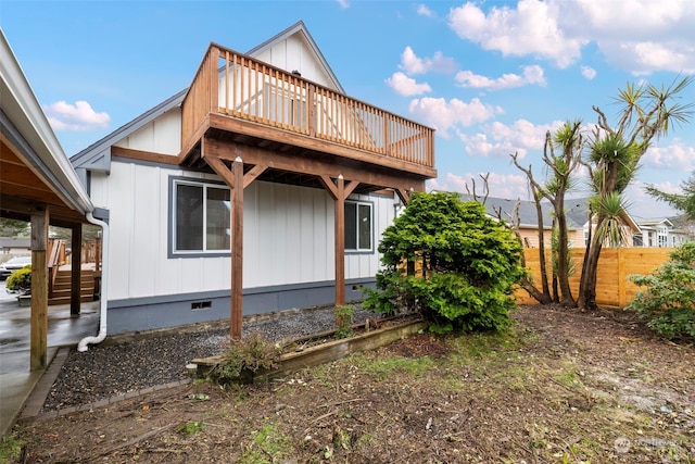 exterior space with a balcony and a wooden deck