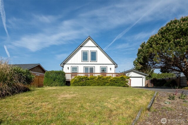 585 Ocean Shores Blvd SW, Ocean Shores, WA 98569 - view of front of property with driveway, board and batten siding, an outdoor structure, a garage, and a front yard