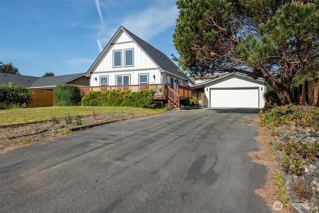 585 Ocean Shores Blvd SW, Ocean Shores, WA 98569 - view of front facade with board and batten siding, a garage, asphalt driveway, and a deck