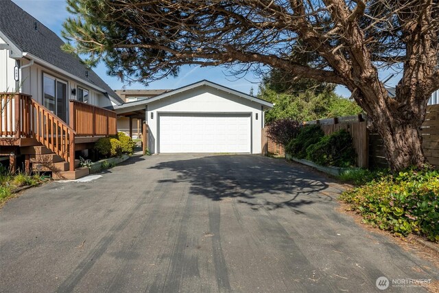 585 Ocean Shores Blvd SW, Ocean Shores, WA 98569 - view of front of property with driveway, roof with shingles, a garage, and fence
